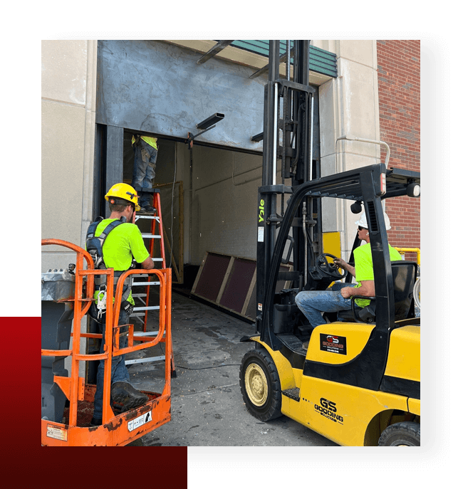 Distribution Worker Working in Warehouse and One Worker Sitting on Forklift